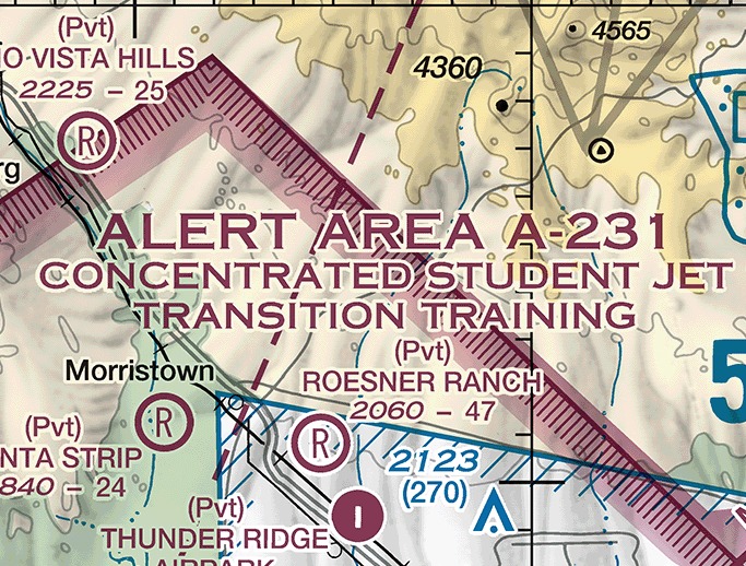 Sectional chart excerpt northwest of Phoenix, Arizona. Three lines of large magenta capitals read ALERT AREA A-231, CONCENTRATED STUDENT JET TRANSITION TRAINING. A magenta line carrying a band of short magenta ticks forms a corner across the upper left and continues down the right side of the frame. Morristown, Roesner Ranch, Thunder Ridge Airpark, and several private airport symbols with their elevation and runway-length figures appear around the text, along with spot elevations and terrain contours.