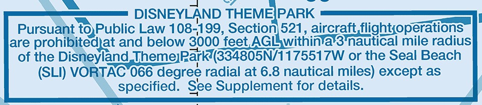 A blue-outlined note box printed on a sectional chart. The heading reads DISNEYLAND THEME PARK, and the text below reads: Pursuant to Public Law 108-199, Section 521, aircraft flight operations are prohibited at and below 3000 feet AGL within a 3 nautical mile radius of the Disneyland Theme Park (334805N/1175517W or the Seal Beach (SLI) VORTAC 066 degree radial at 6.8 nautical miles) except as specified. See Supplement for details.