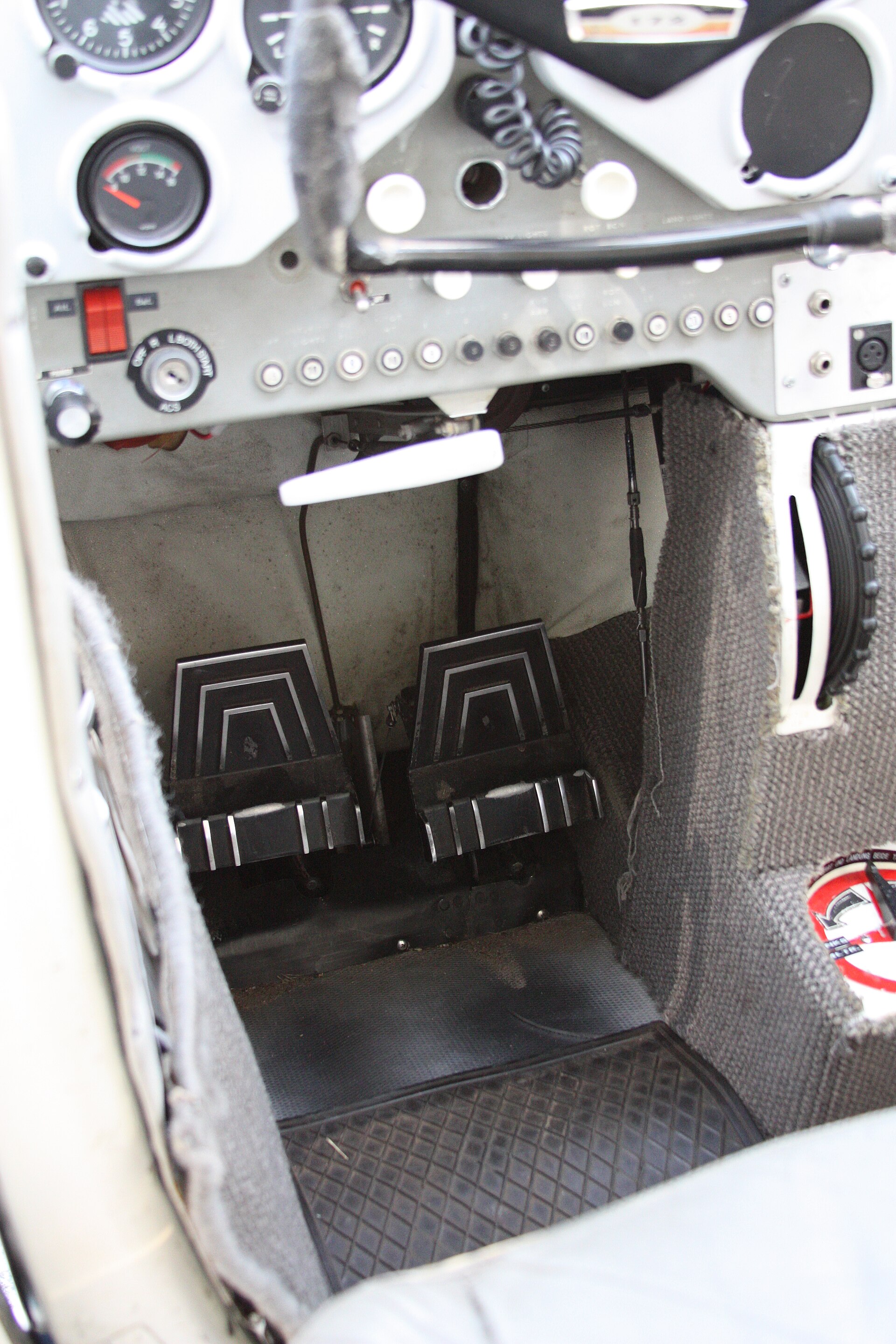 The rudder pedals on the floor of a Cessna 172